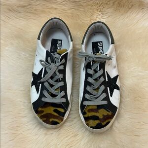 Golden Goose Black and White Star Sneakers with Camo Accents